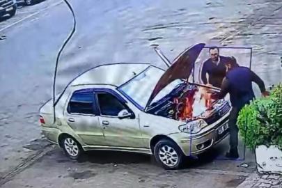 Alev alan otomobili üfleyerek söndürmeye çalıştı: O anlar kamerada