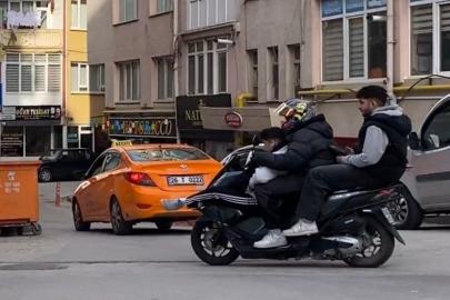 Motosiklette üç kişilik tehlikeli yolculuk